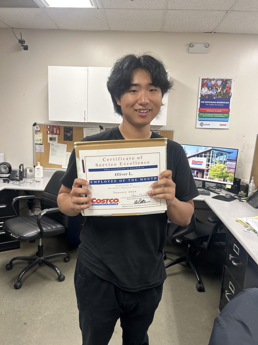 Oliver Lim holding his Costco Employee of the Month certificate